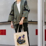 mockup-of-a-man-in-a-cosplay-costume-carrying-a-sublimated-tote-bag-m33609